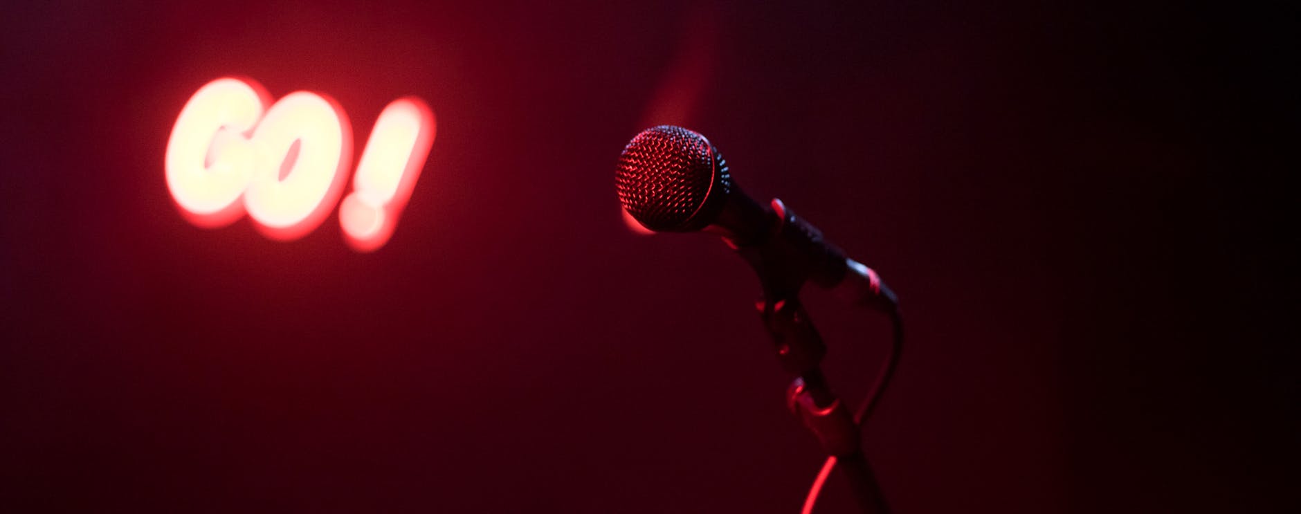 microphone on a stand with a red background and lighting
