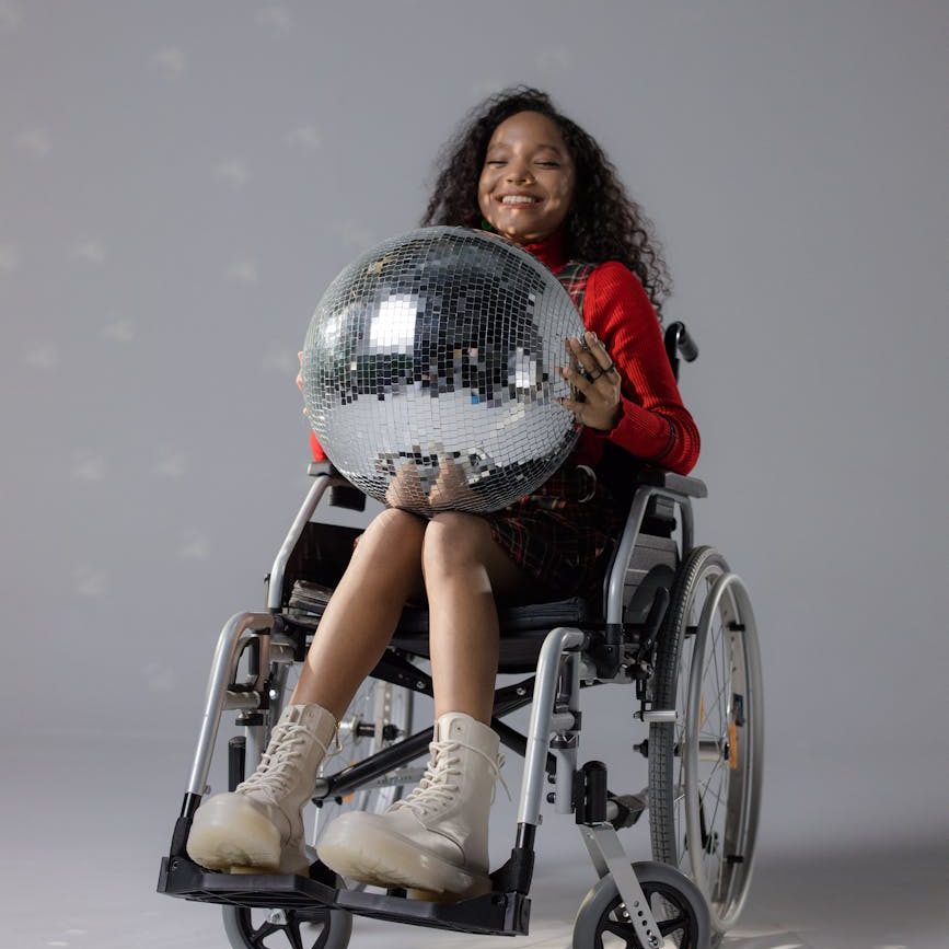 girl smiling while holding a disco ball